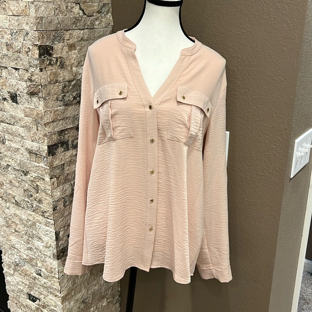 Light pink button down women’s dress shirt with gold accent buttons